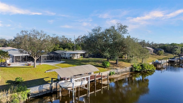 dock area with a yard, a water view, and glass enclosure