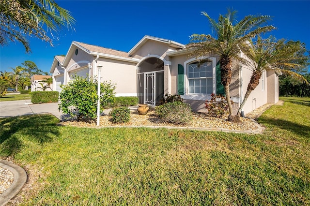 view of front of property featuring a garage and a front lawn