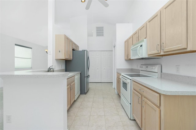 kitchen with light countertops, visible vents, light brown cabinetry, white appliances, and a peninsula