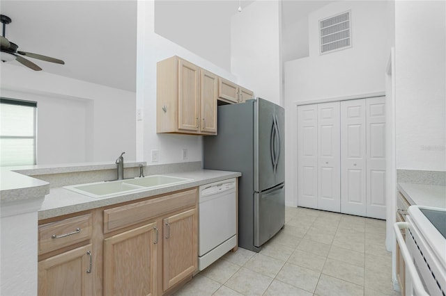 kitchen with sink, dishwasher, ceiling fan, light tile patterned floors, and light brown cabinetry