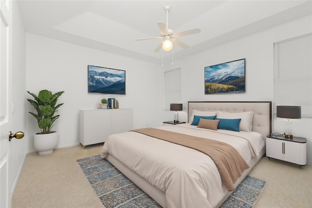 bedroom with a raised ceiling, a ceiling fan, and baseboards