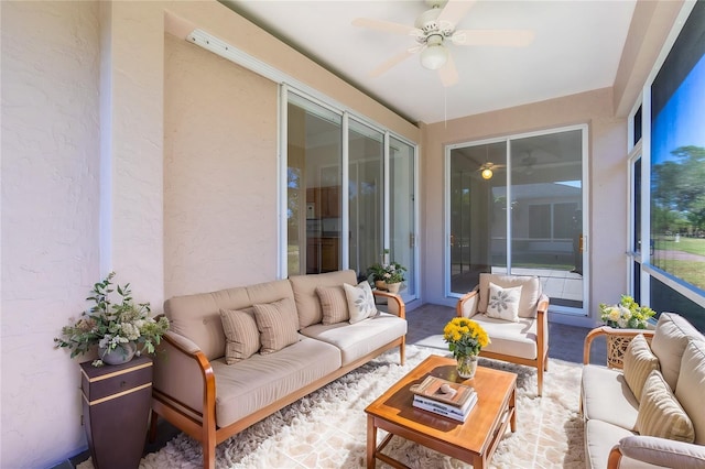 sunroom featuring a ceiling fan