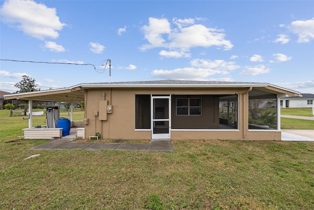 back of property featuring a yard and a sunroom