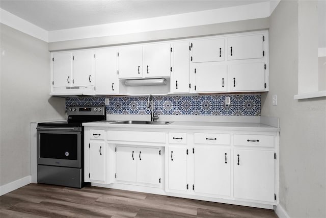 kitchen with under cabinet range hood, a sink, white cabinetry, light countertops, and stainless steel electric range oven