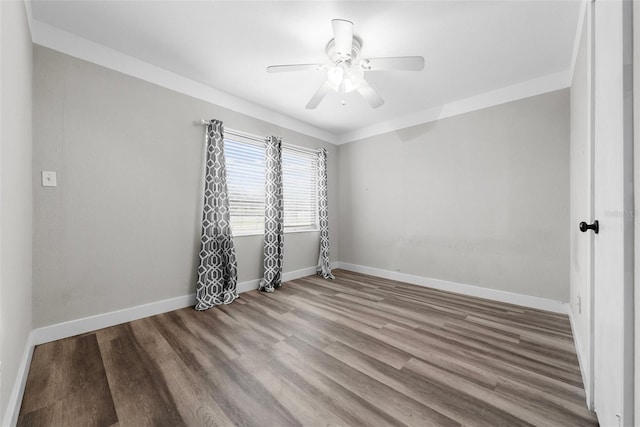 unfurnished room featuring a ceiling fan, baseboards, and wood finished floors