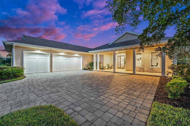 view of front of home featuring a porch and a garage