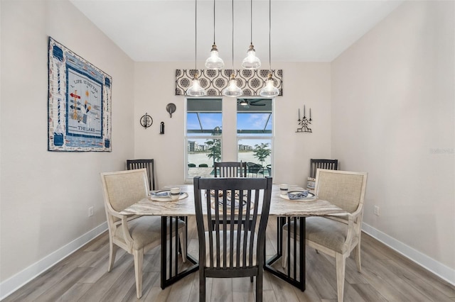 dining room featuring hardwood / wood-style floors and a notable chandelier