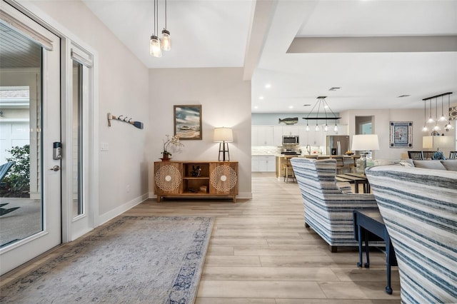 interior space featuring a chandelier, sink, and light hardwood / wood-style flooring