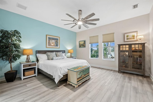 bedroom with ceiling fan and light hardwood / wood-style floors