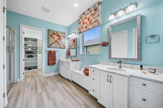 bathroom featuring vanity, a shower with shower door, and hardwood / wood-style flooring