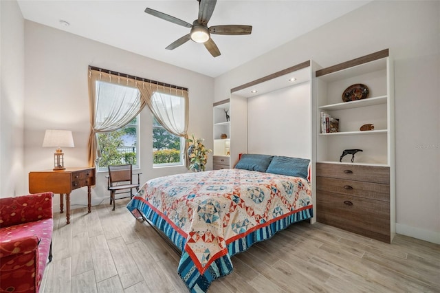 bedroom with ceiling fan and light hardwood / wood-style flooring