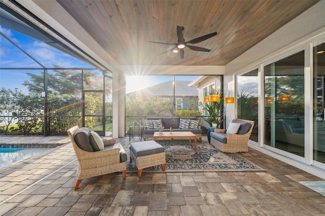 sunroom with ceiling fan and wooden ceiling