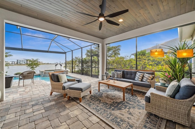 sunroom with ceiling fan, a swimming pool, and wooden ceiling