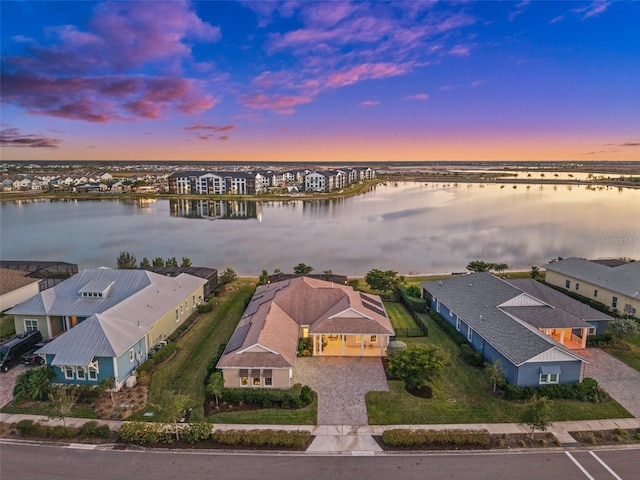 aerial view at dusk with a water view