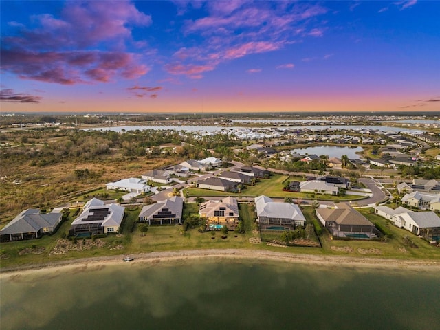 aerial view at dusk with a water view