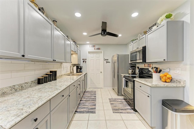 kitchen with gray cabinetry, ceiling fan, sink, light tile patterned floors, and appliances with stainless steel finishes