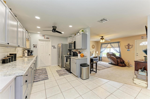 kitchen with light carpet, stainless steel appliances, gray cabinets, and sink