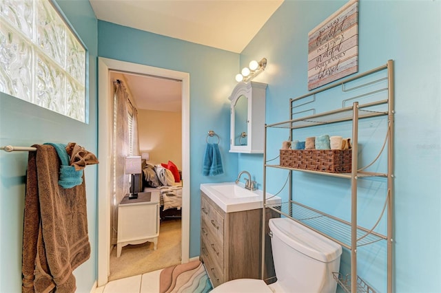 bathroom featuring tile patterned flooring, vanity, and toilet