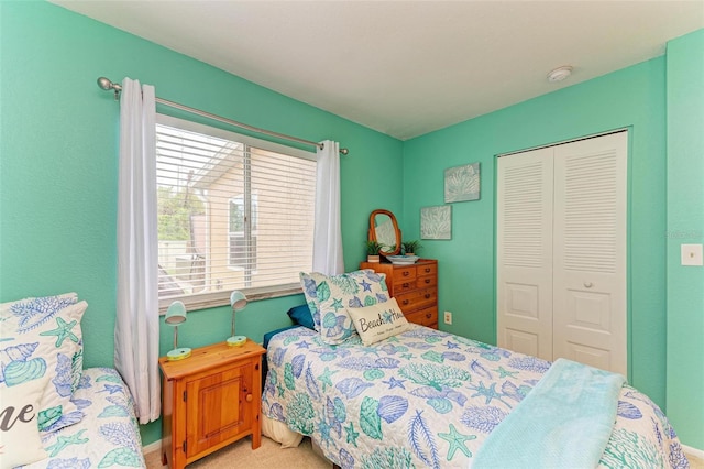 bedroom featuring multiple windows, light carpet, and a closet