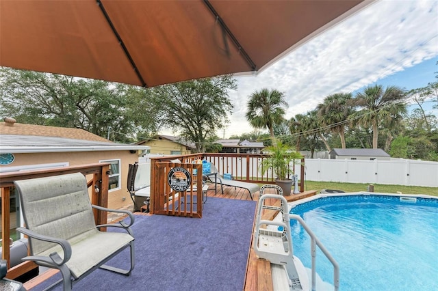 view of swimming pool with a wooden deck