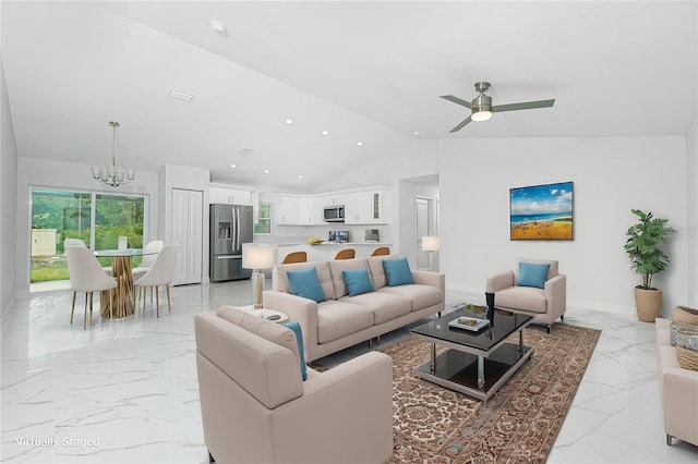 living room featuring ceiling fan with notable chandelier and lofted ceiling