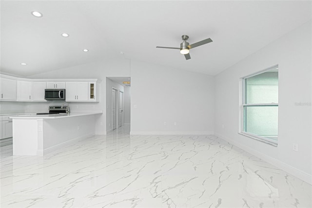 unfurnished living room with ceiling fan and vaulted ceiling