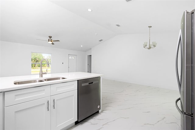 kitchen featuring decorative light fixtures, sink, white cabinetry, appliances with stainless steel finishes, and ceiling fan with notable chandelier