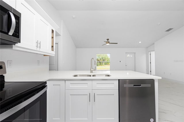 kitchen with stainless steel appliances, white cabinets, and sink