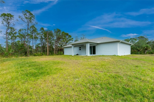 rear view of house with a lawn