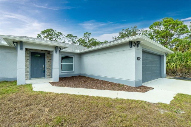 exterior space featuring a garage and a lawn