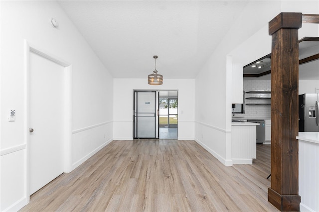 unfurnished room featuring light hardwood / wood-style floors and a textured ceiling