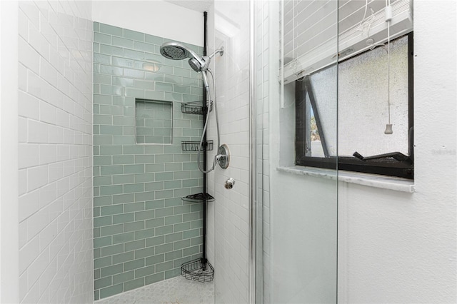 bathroom with tiled shower