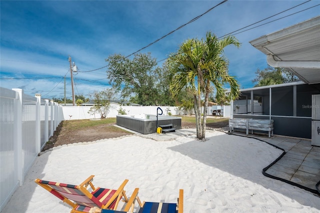 view of yard featuring a patio, a hot tub, and a sunroom