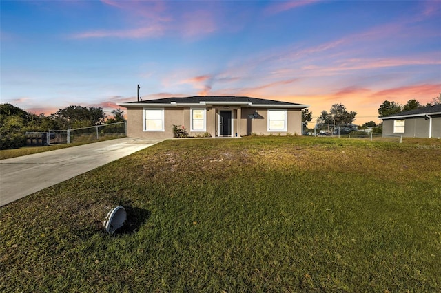 ranch-style house with a lawn