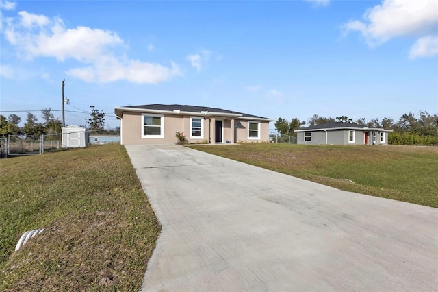 ranch-style home with a shed and a front yard