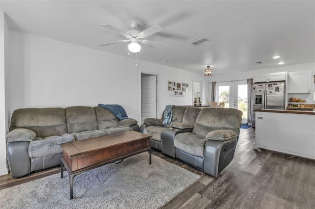 living room featuring ceiling fan, dark wood-type flooring, and french doors