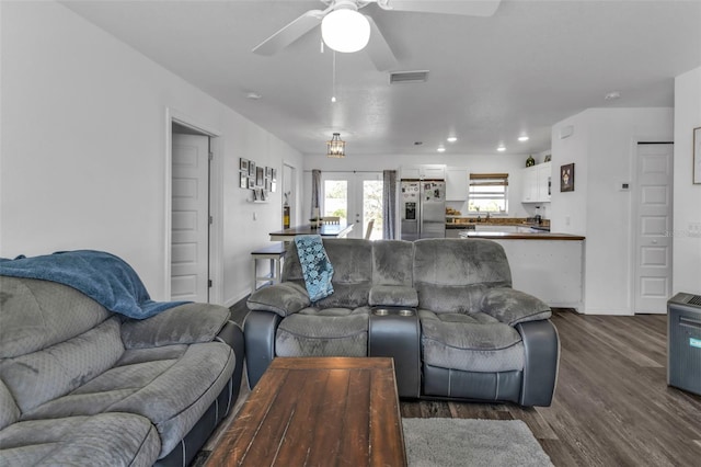 living room with french doors, ceiling fan, dark wood-type flooring, and sink