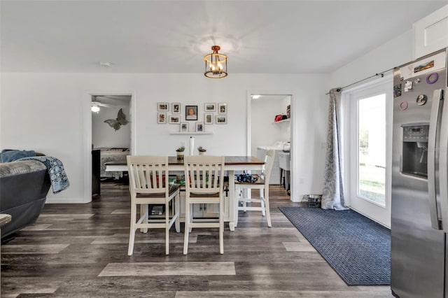 dining area featuring a chandelier and dark hardwood / wood-style flooring