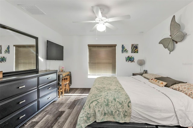 bedroom with ceiling fan and dark wood-type flooring