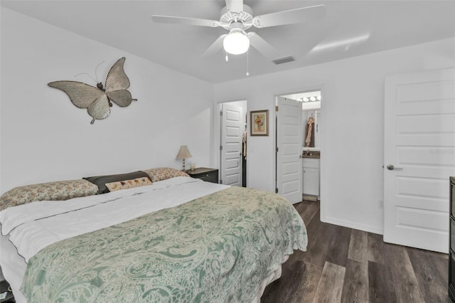 bedroom featuring ceiling fan, dark hardwood / wood-style floors, and connected bathroom