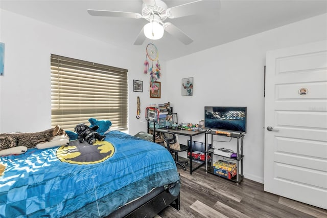 bedroom with ceiling fan and dark wood-type flooring