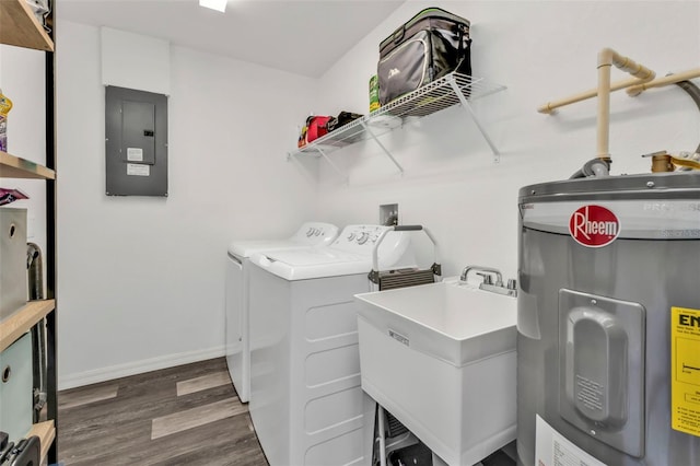 clothes washing area with sink, dark wood-type flooring, electric water heater, independent washer and dryer, and electric panel