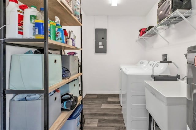 washroom with washing machine and clothes dryer, electric panel, sink, and dark wood-type flooring