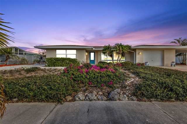 ranch-style home featuring a garage