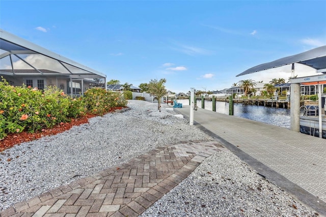 dock area with a water view and glass enclosure