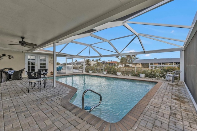 view of pool featuring a lanai, a patio, and french doors