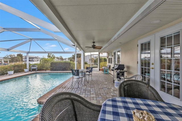 view of pool with a lanai, area for grilling, and a patio