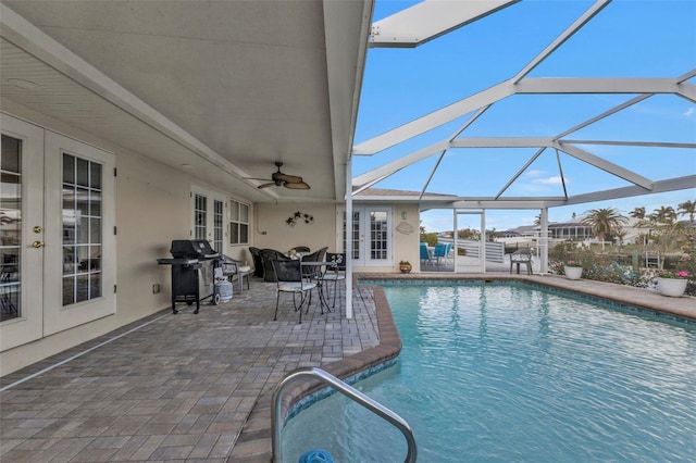 view of pool featuring grilling area, a patio area, french doors, and glass enclosure