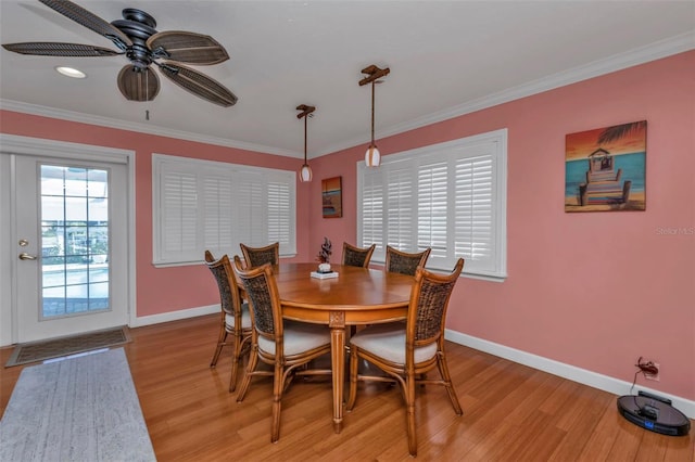 dining space featuring ceiling fan, light hardwood / wood-style floors, and crown molding