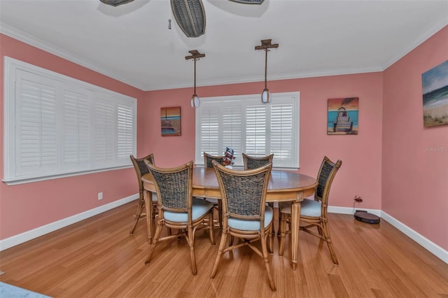 dining room with light hardwood / wood-style flooring, ceiling fan, and ornamental molding